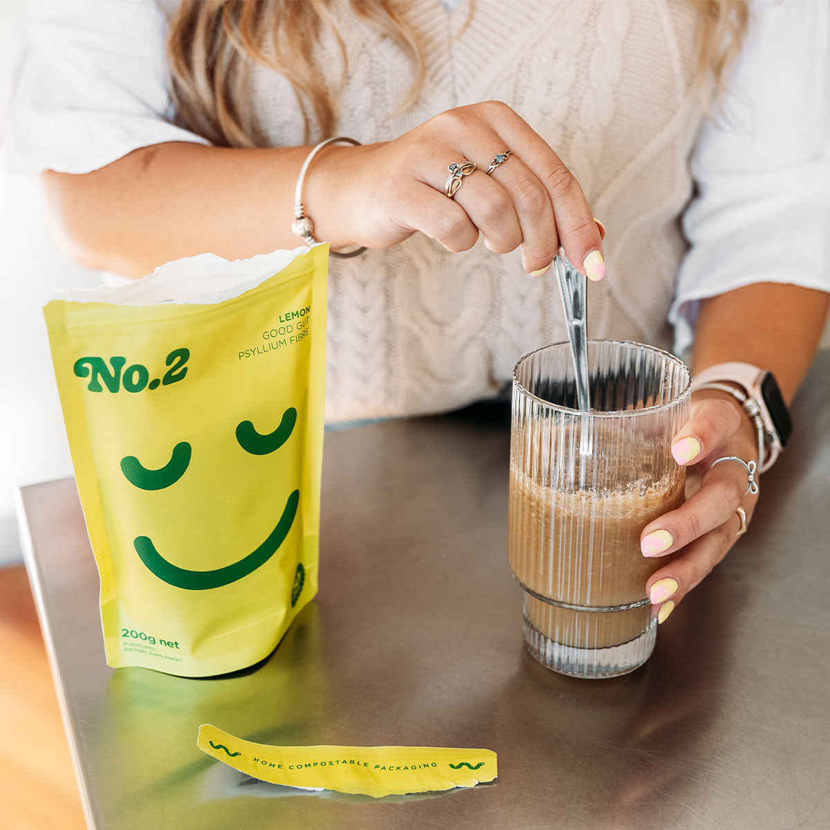 Person stirring some No.2 into a glass