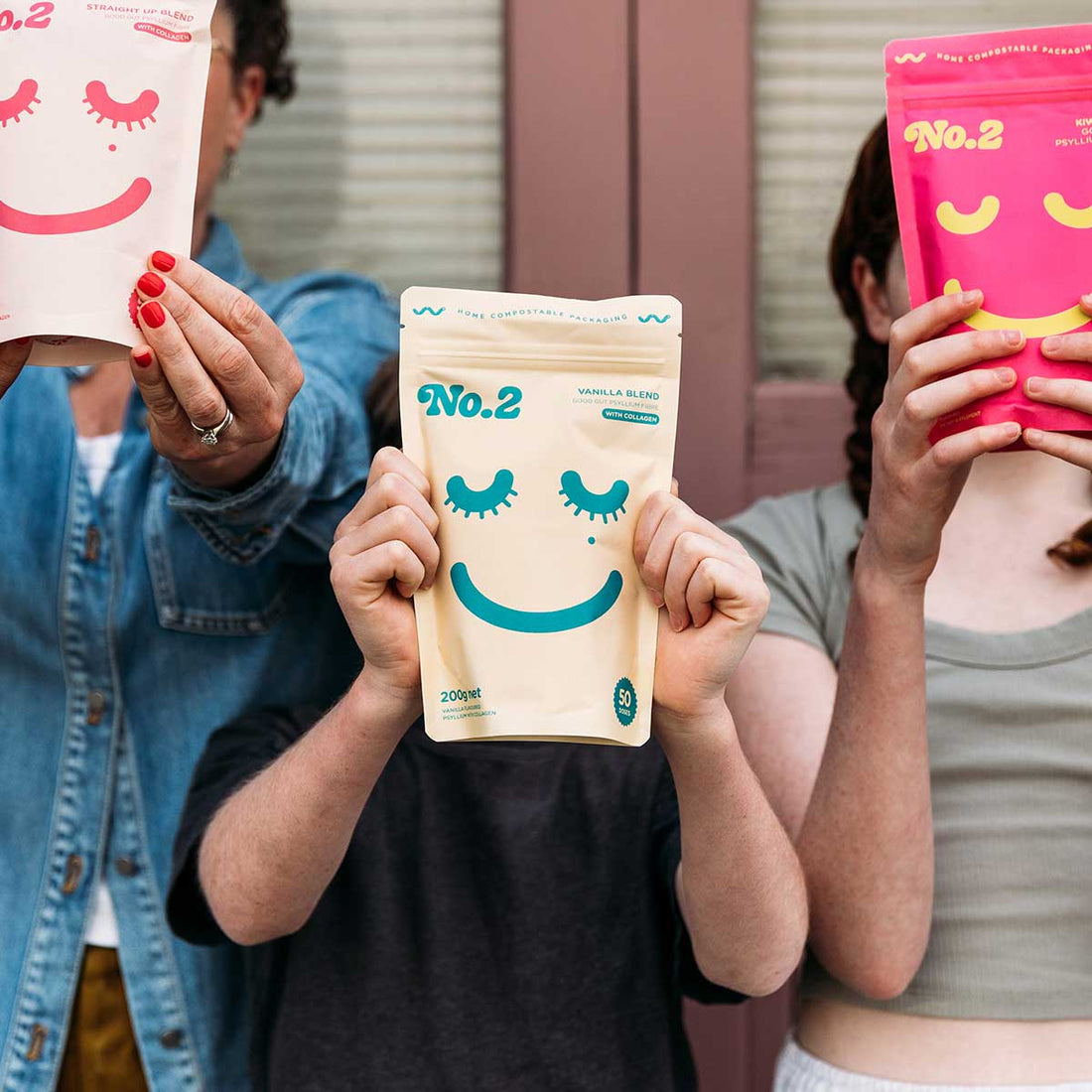 People holding up packets of No.2 Good Gut Fibre